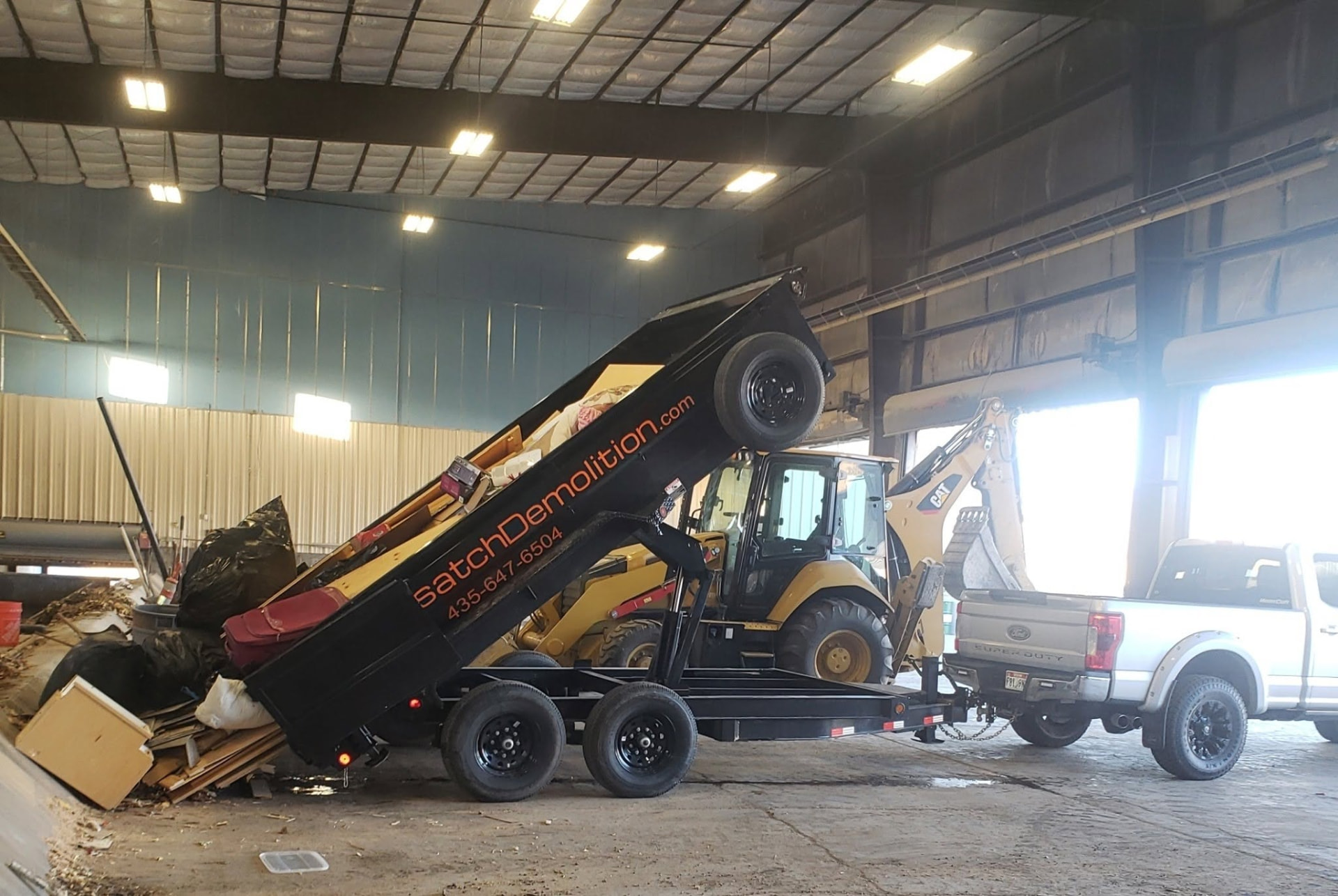 Wasatch Demolition dump trailer being loaded with demolition debris at a warehouse job in Park City, UT