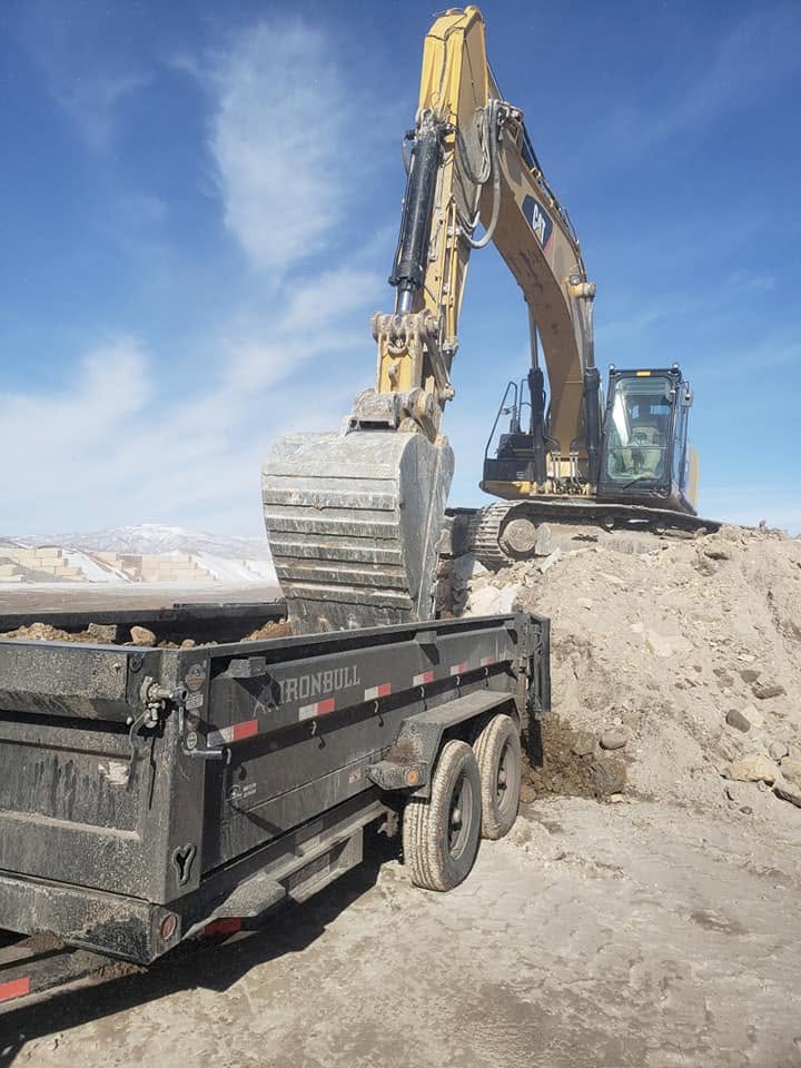 Wasatch Demolition excavator loading dirt for hauling on a Park City, UT job site